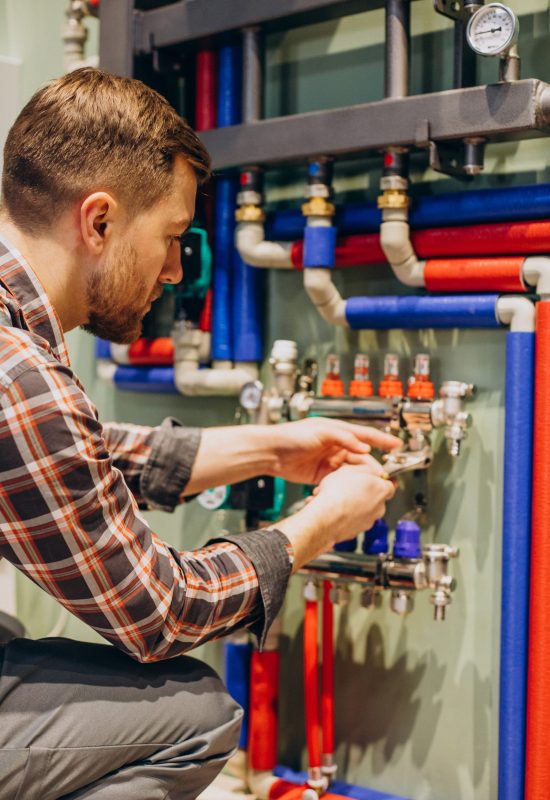 Young engineer adjusting autonomous heating