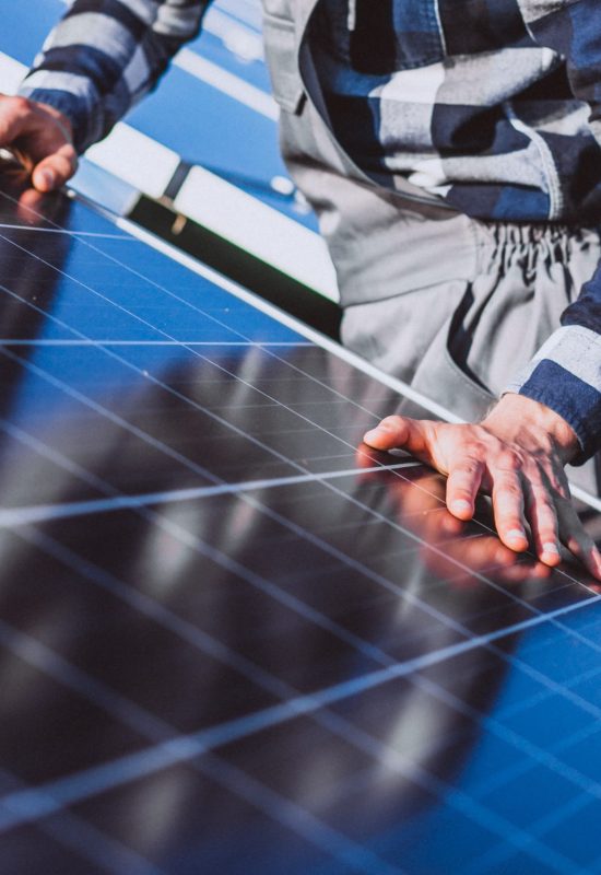 Man worker in the firld by the solar panels